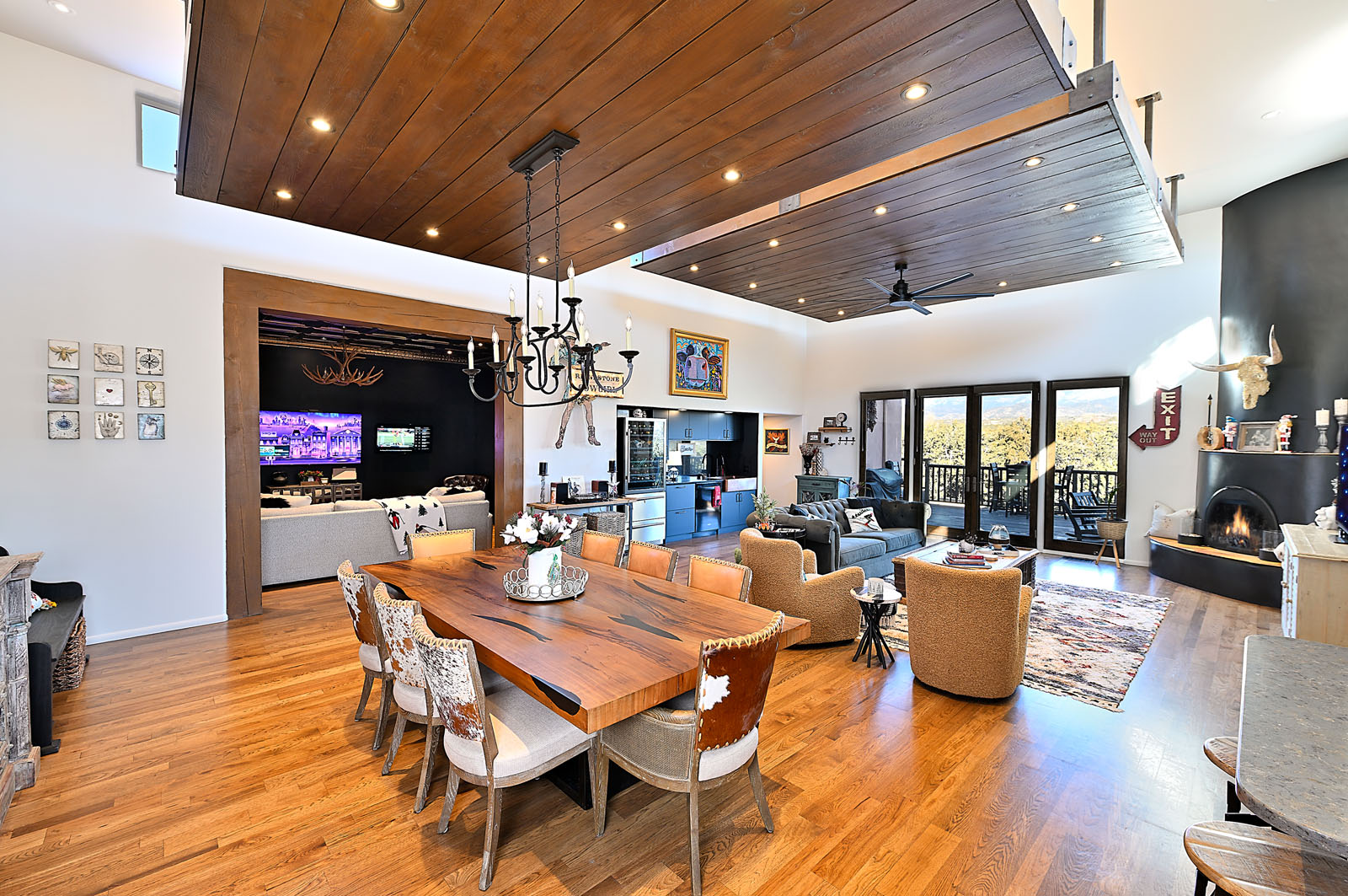 Elegant and spacious dining and living area with vaulted wooden ceilings and modern furnishings in a Santa Fe home.