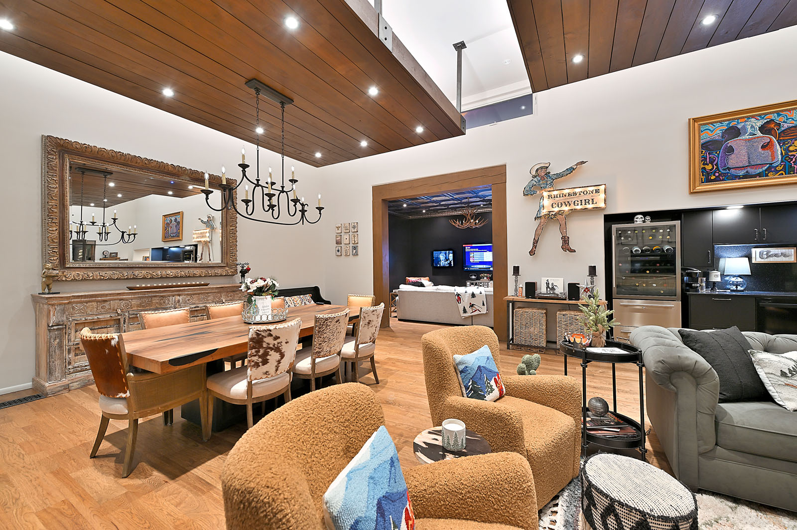 Elegant and welcoming open-plan living space in a Santa Fe home, combining a comfortable sitting area, stylish dining setup, and an integrated modern kitchen.